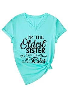 Detail of mint green V-neck t-shirt with I'M THE OLDEST SISTER black print and side knot