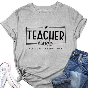 Flat lay of gray Teacher Mode t-shirt styled with blue jeans and white sneakers
