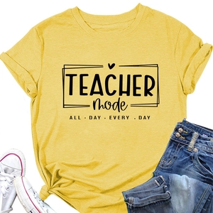Flat lay of mustard yellow t-shirt with teacher mode slogan and rolled sleeve detail