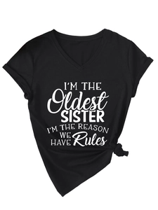 Detail view of V-neck black sister T-shirt with white text and knotted hem styling