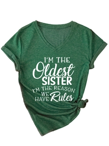 Detail of dark green V-neck T-shirt with oldest sister slogan print and rolled sleeves
