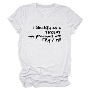 Gros plan du slogan 'I identify as a THREAT' imprimé sur un t-shirt blanc en coton