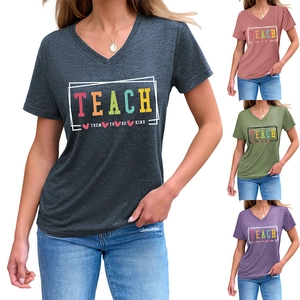 Detail view of V-neck T-shirts in four colors featuring Teach Them To Be Kind print