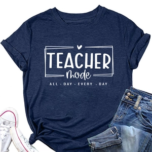 Flat lay of navy blue Teacher Mode t-shirt styled with denim jeans and sneakers