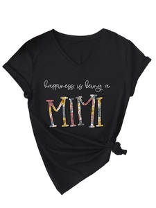 Detail of V-neck black T-shirt featuring floral Mimi text and stylish side knot design
