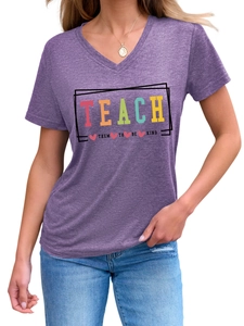 Detail of V-neck heather purple T-shirt with 'TEACH THEM TO BE KIND' colorful print