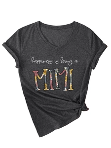 Macro shot of V-neck T-shirt detail with floral MIMI print and knotted hem