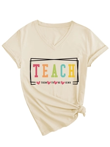 Detail of V-neck apricot T-shirt with Teach Them To Be Kind slogan and heart print