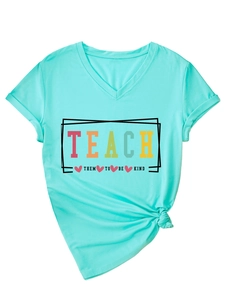Close-up of V-neck T-shirt detail with Teach Them To Be Kind slogan and tied hem