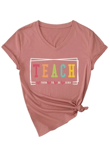 Close-up of V-neck mauve t-shirt with Teach Them To Be Kind colorful lettering