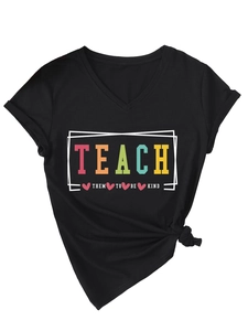 Detail of V-neck black T-shirt featuring colorful Teach Them To Be Kind slogan print