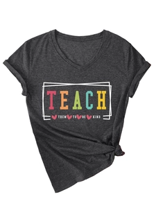 Detail of V-neck grey t-shirt featuring Teach Them To Be Kind print and side knot