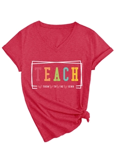 Detail of red V-neck T-shirt with TEACH THEM TO BE KIND slogan and side knot design