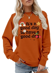 Détail du sweat orange avec imprimé marguerite arc-en-ciel et slogan motivant