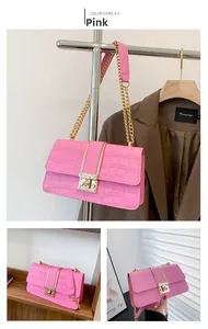 Detail of pink faux crocodile leather shoulder bag with gold chain and twist lock clasp