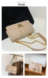 Detail view of khaki crocodile embossed crossbody bag with gold chain and metal clasp