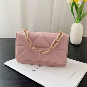 Detail of pink quilted handbag with mixed resin and gold metal chunky chain strap