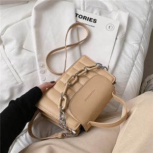 Detail of beige quilted PU leather crossbody bag with decorative thick chain and top handle