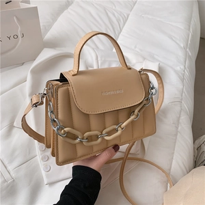 Chic quilted beige shoulder bag with stylish acrylic chain and adjustable strap
