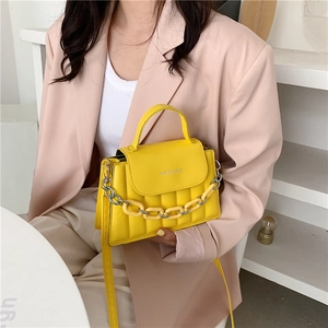 Fashionable bright yellow quilted crossbody bag with stylish chain strap and top handle
