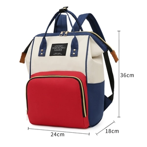 Vue détaillée du sac à langer tricolore avec poche rouge et dimensions indiquées