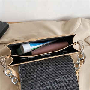 Internal view of beige quilted chain bag showing dual compartments and storage space