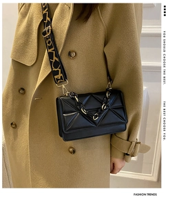 Quilted black flap shoulder bag with chunky gold-tone chain and wide geometric strap