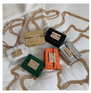 Macro view of mini crocodile pattern chain bags in six vibrant colors with gold clasps