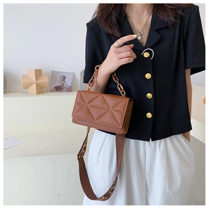 Brown quilted crossbody bag featuring a classic chain handle and patterned strap