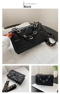 Detail of black geometric quilted crossbody bag with chunky gold chain and wide strap