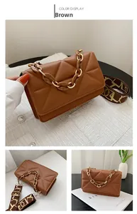 Detail of brown quilted crossbody bag with amber resin chain and printed canvas strap