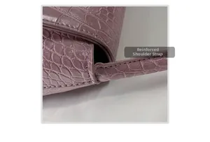 Detail of reinforced shoulder strap stitching on purple crocodile pattern leather bag