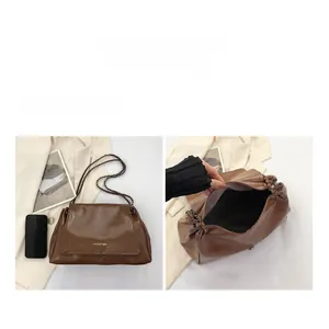 Detail view of large capacity dark brown PU leather crossbody bag showing inner storage