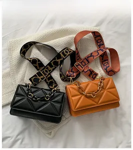 Detail of crossbody bags with geometric triangles, chain handles and woven straps