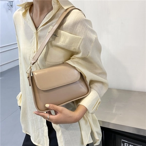 Minimalist beige faux leather crossbody flap bag shown with model for daily style