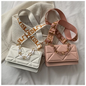 Detailed close-up of quilted crossbody bags with woven straps and chunky chain decor