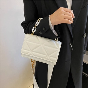 White geometric quilted shoulder bag with gold chain and printed wide fabric strap