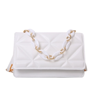 White quilted crossbody bag with chunky chain and orange patterned woven strap