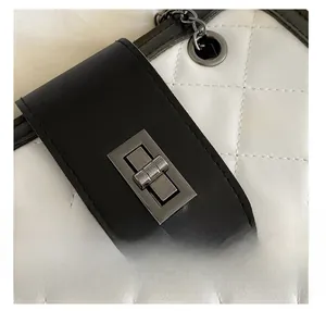 Detailed macro view of quilted leather texture and silver turn-lock metal hardware