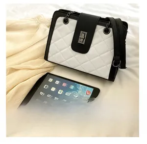 Detailed comparison of the quilted chain bag next to an iPad for size reference