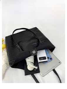 Spacious black woven tote bag interior showing capacity for tablet, diary, and essentials