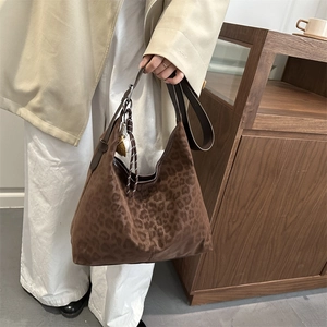 Large leopard print hobo bag with leather strap and knot tassel accessory