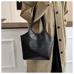 Detail of black woven texture on a minimalist tote bag for daily commute and casual style