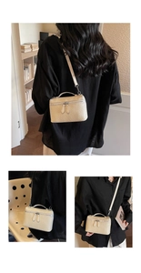 Detailed view of woven texture small square crossbody bag with chain and top handle