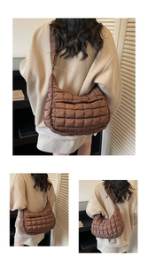 Detail view of the brown quilted crescent bag featuring soft nylon texture and stitching