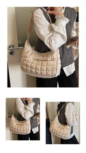 Detailed close-up of beige quilted tote bag showing square stitching and soft texture