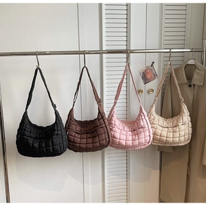 Close-up of quilted puffy shoulder bags in black, coffee, pink, and off-white colors