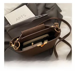Interior view showing large capacity of the brown bucket bag with phone and wallet