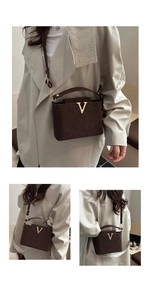 Detail showing deep brown crossbody bag with gold V-buckle from multiple angles