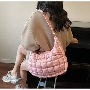 Pink quilted cloud bag with padded texture and wide shoulder strap for women